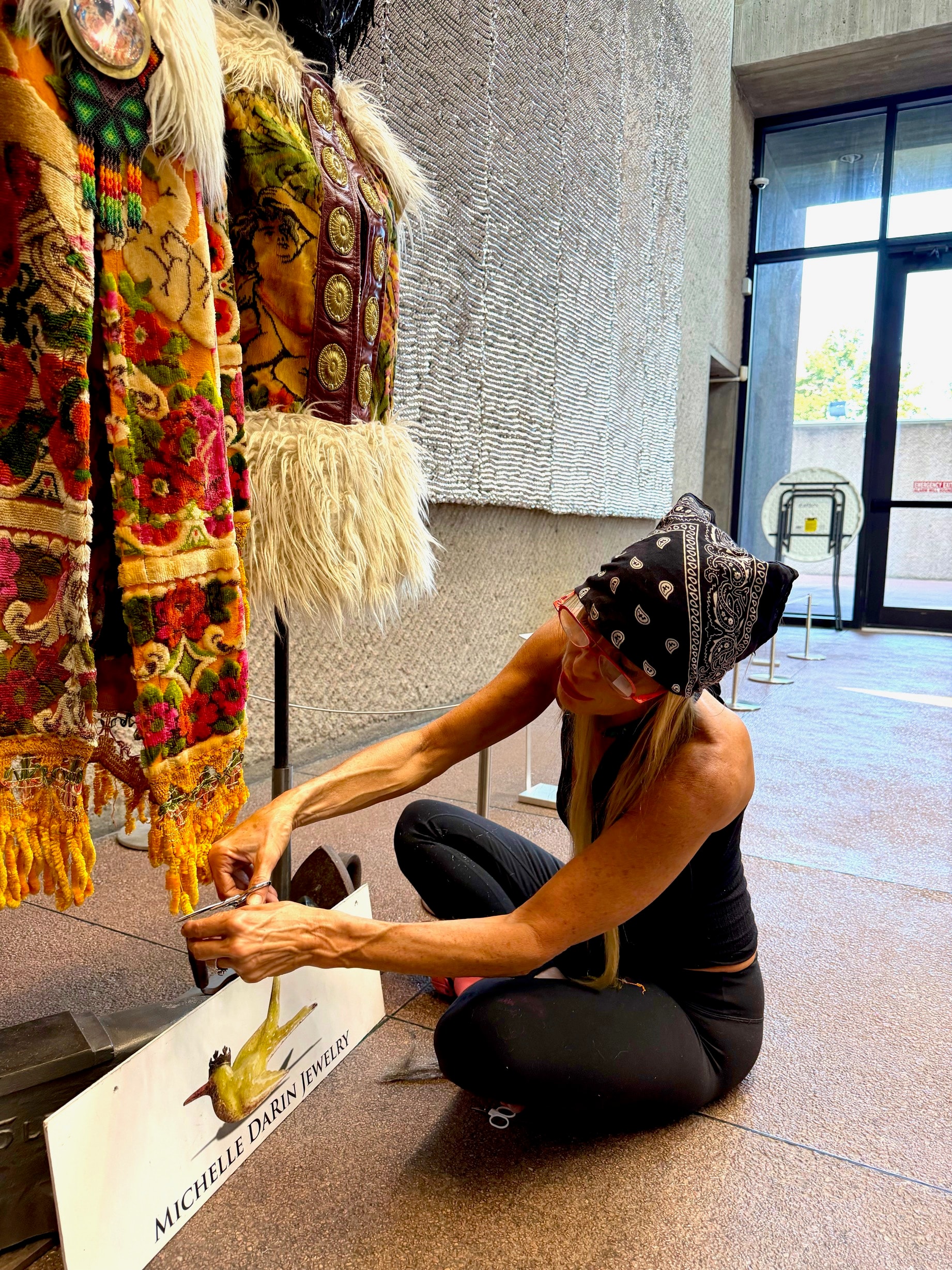 Michelle DaRin setting up her jewelry installation at the museum