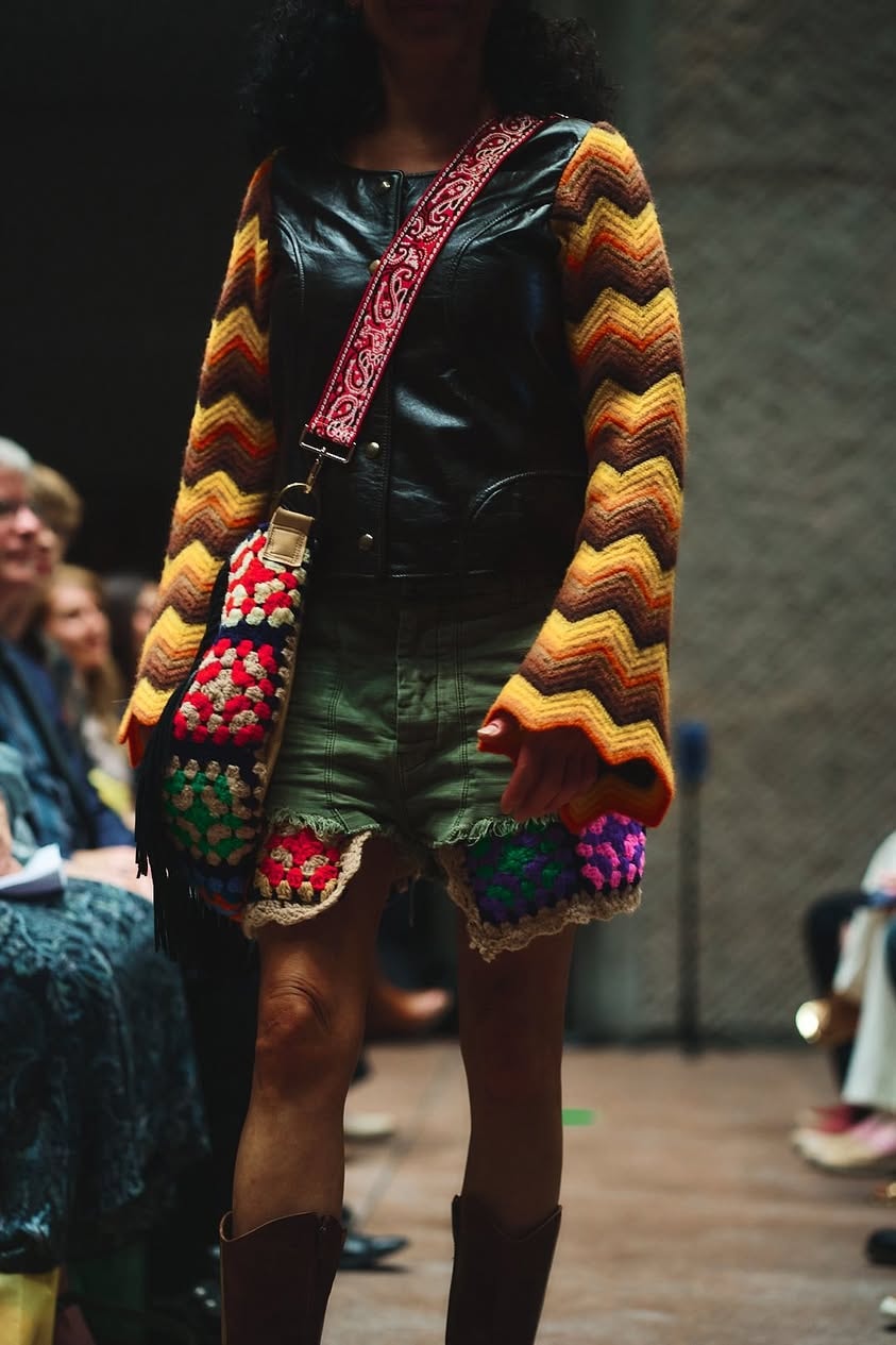 Runway model in chevron crochet cardigan and granny square bag